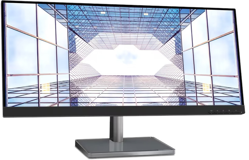 Een computermonitor toont een opwaartse weergave van de glazen gevel van een wolkenkrabber, tegen een blauwe lucht. De monitor staat op een standaard.