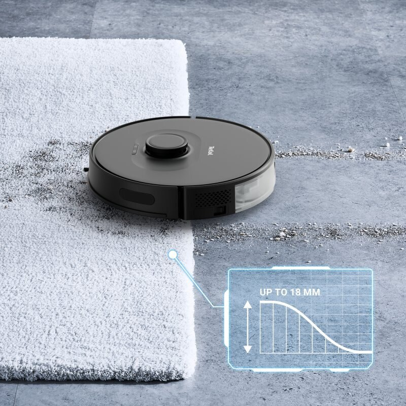 Czarny odkurzacz robot na szarej podłodze, czyszczący w pobliżu białego dywanu. Wykres pokazuje do 18 mm.