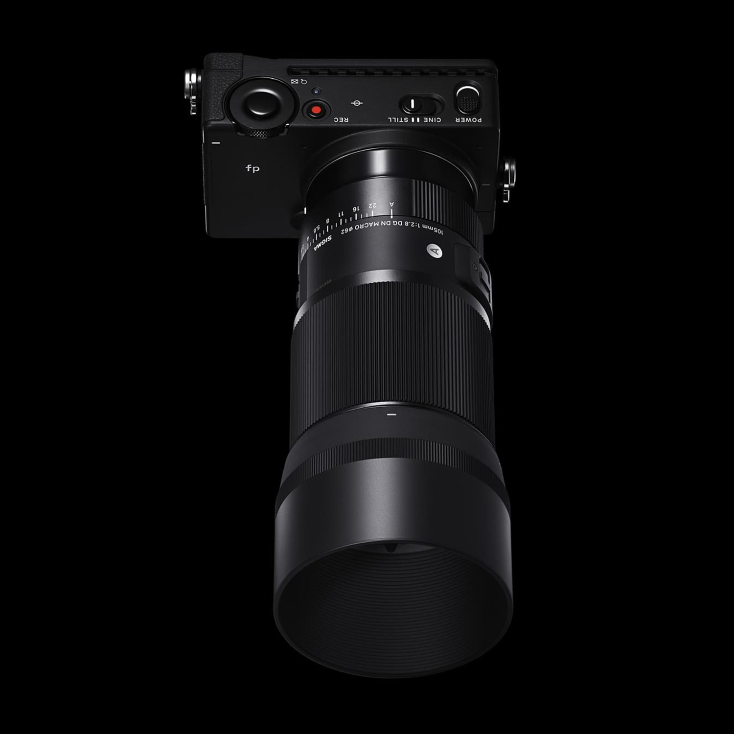 Fotocamera nera con un lungo obiettivo, angolata su sfondo nero.