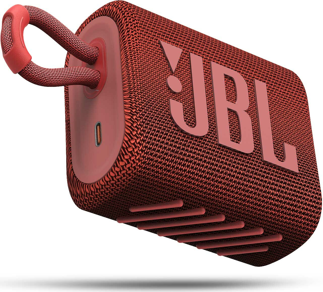 Czerwony głośnik JBL z uchwytem pętelkowym i portem USB.