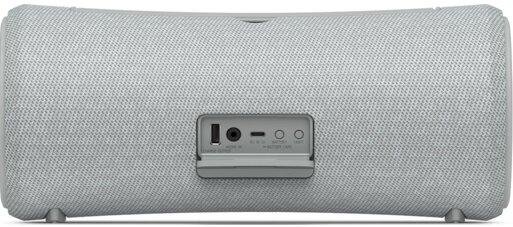 Jasnoszary głośnik z panelem portów. Porty obejmują USB, wejście DC i przycisk.