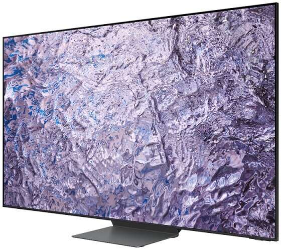 Duży telewizor z falistym, abstrakcyjnym obrazem na ekranie. Telewizor ma podstawę.