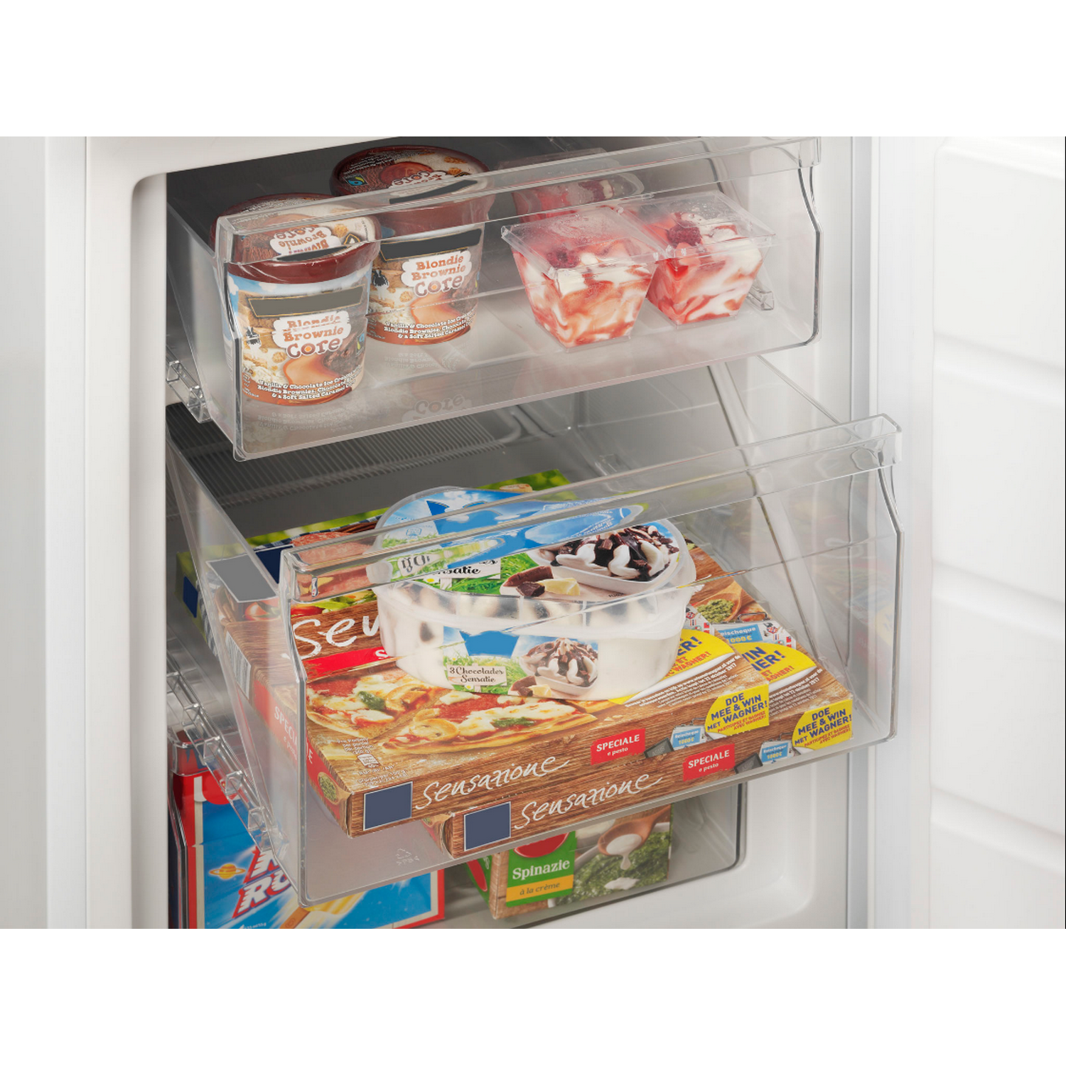 Refrigerator interior with frozen food containers in clear drawers.