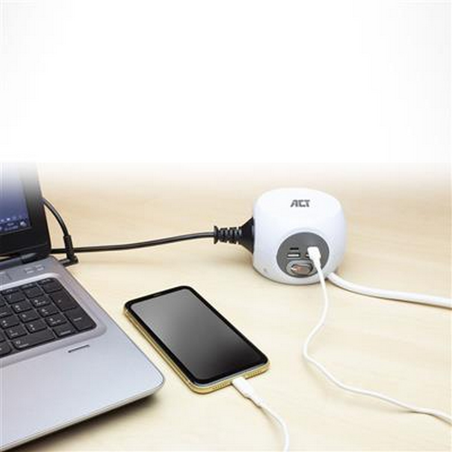 White power adapter with multiple ports, connected to a laptop and phone. White background.