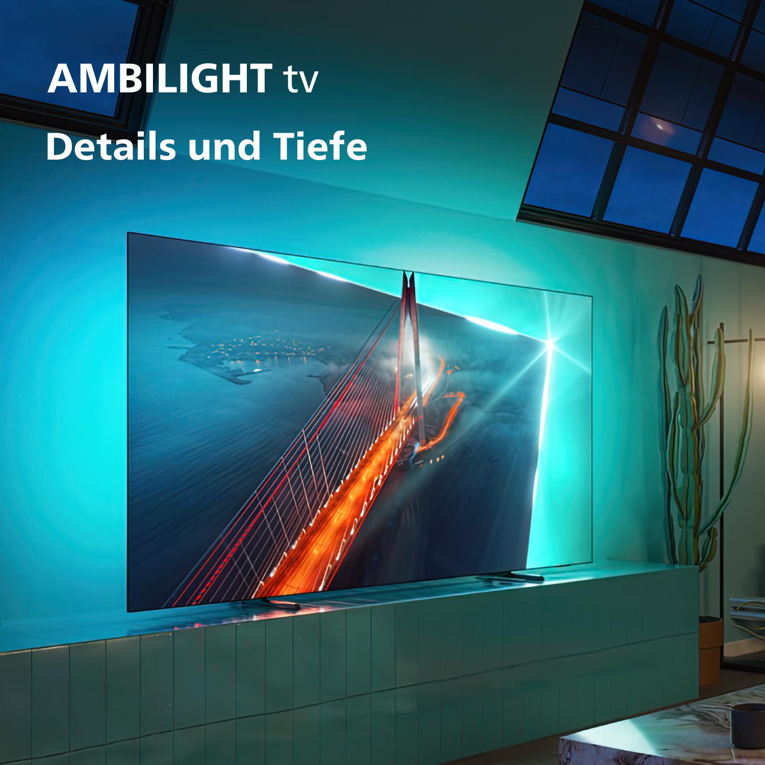 Ein moderner Fernseher mit Ambilight an einer Wand. Der Bildschirm zeigt eine Brücke mit Lichtern.