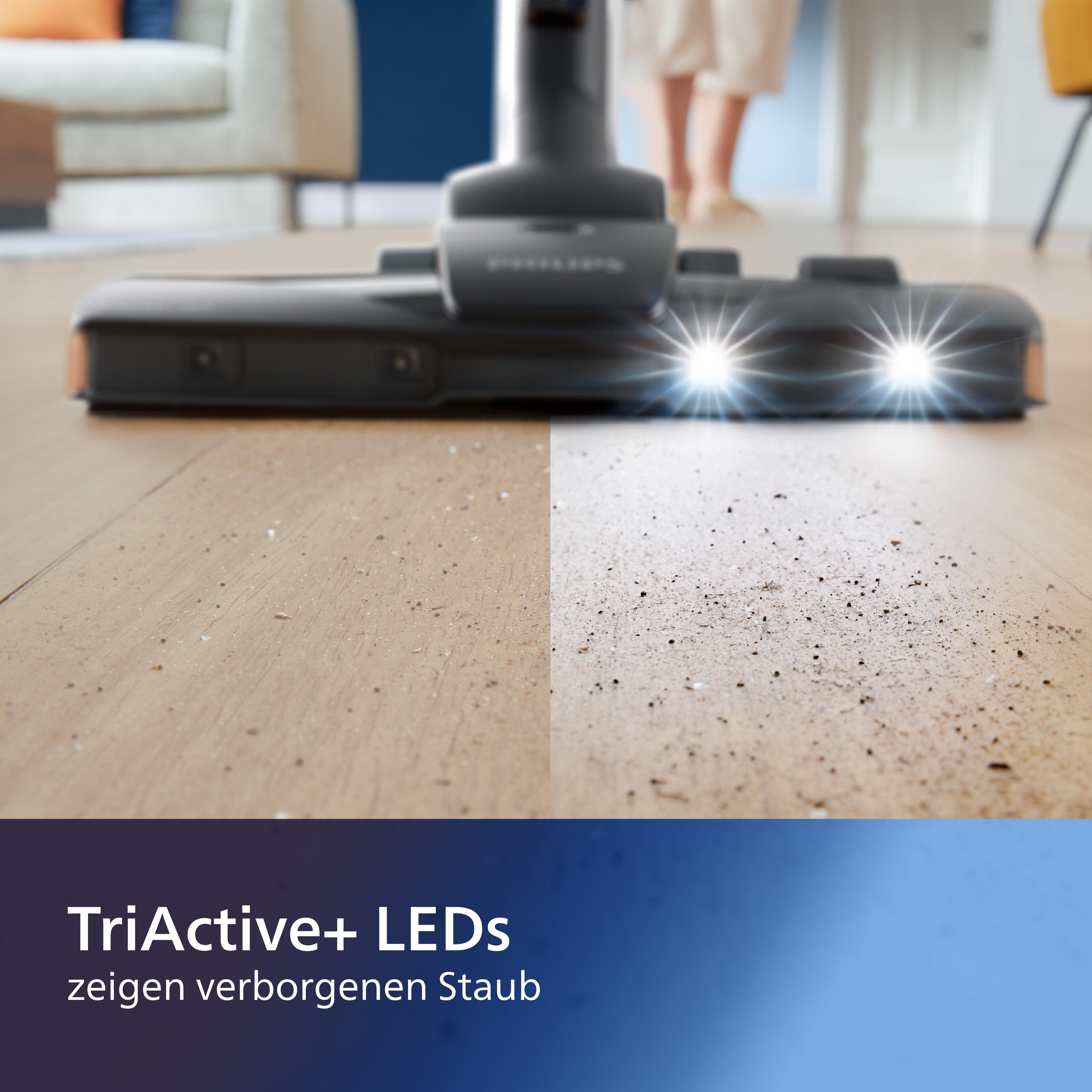 Staubsaugerkopf mit LED-Leuchten, die einen Holzboden beleuchten. Der Reiniger zeigt saubere und schmutzige Bereiche.