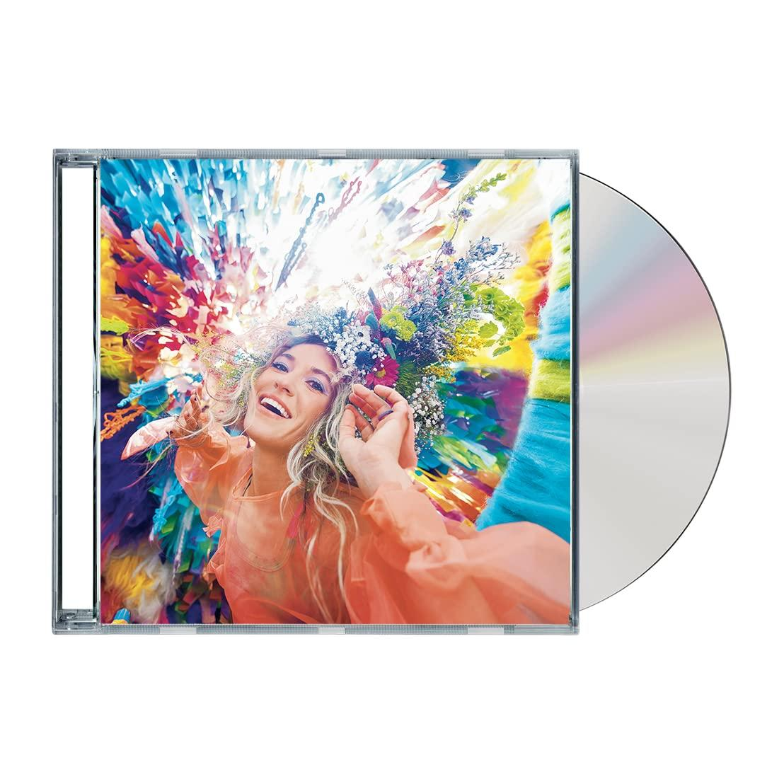 CD-Hülle mit einer Frau auf dem Cover, umgeben von Blumen. Eine CD liegt neben der Hülle.