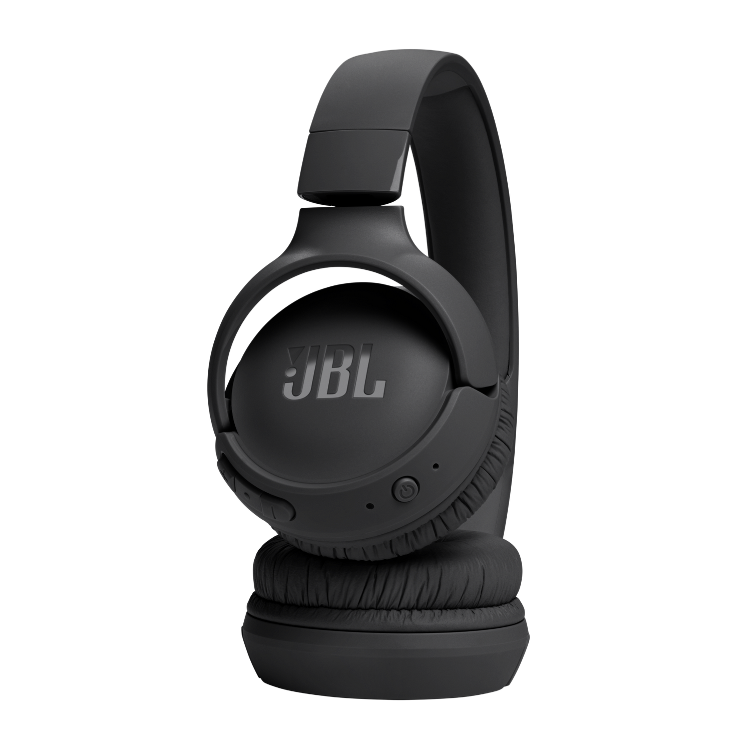 Black JBL headphones on black background. Headband arches over the ear cups.