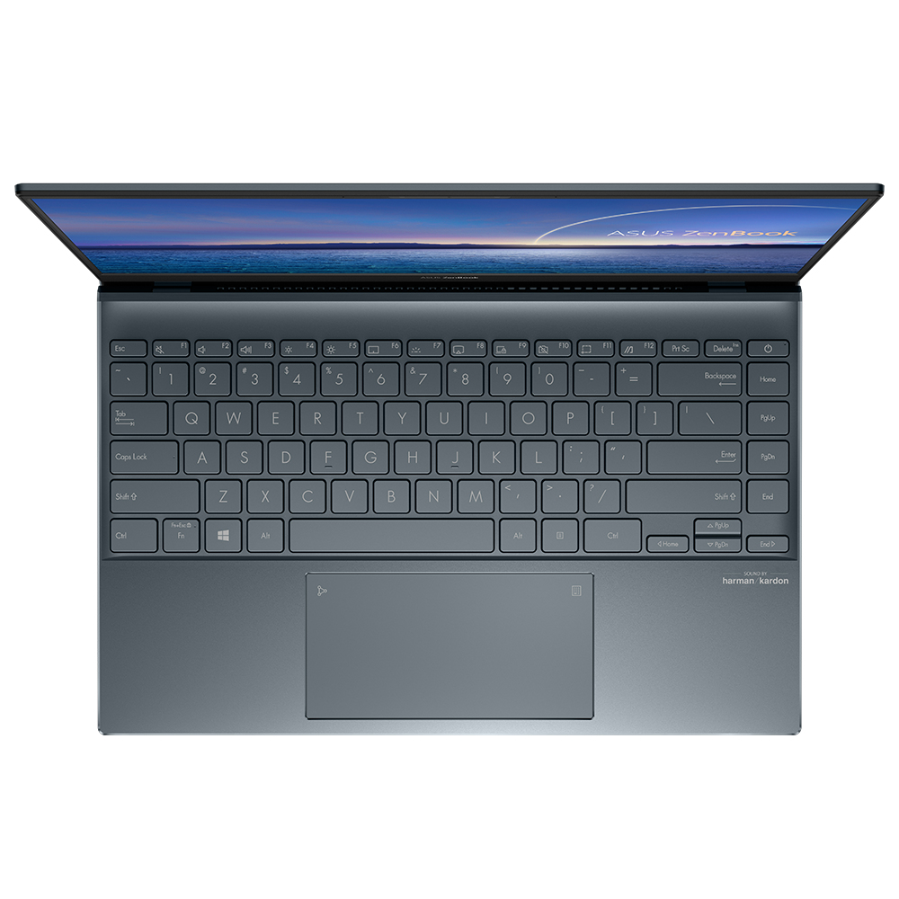 Draufsicht auf Laptop, geöffnet. Tastatur sichtbar, Bildschirm zeigt Landschaft.