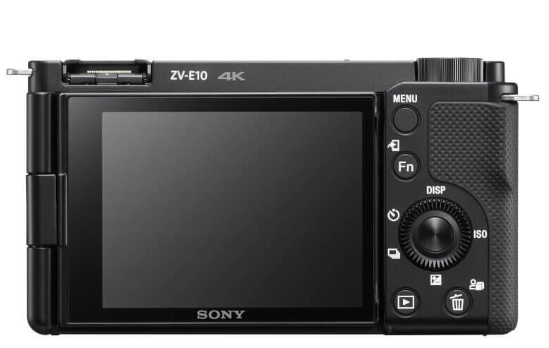 Czarny aparat z ekranem, przyciskami i pokrętłem z tyłu.