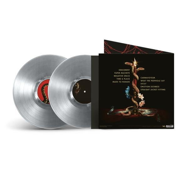 Két ezüst hanglemez egy tokban album grafikával és szám listával, fehér felületen.