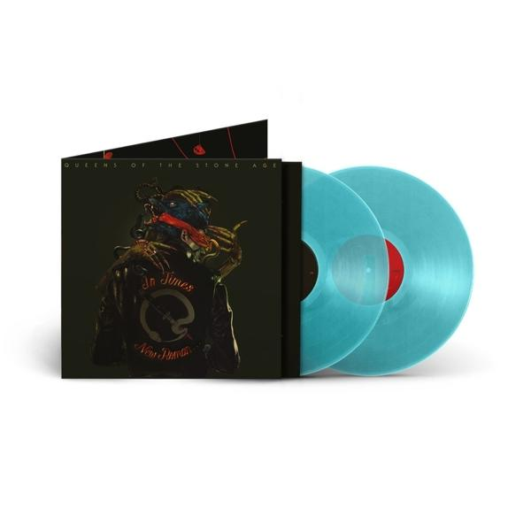 Queens of the Stone Age Vinyl-Schallplatte. Blaue Schallplatte, Albumcover zeigt eine Figur in einer Jacke. Weißer Hintergrund.