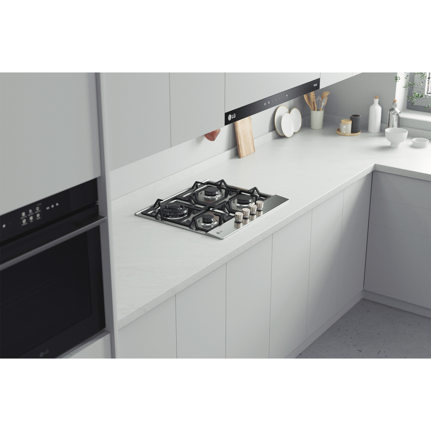 Interno cucina moderna con piano cottura a gas incorporato. Mobili e piano di lavoro bianchi.