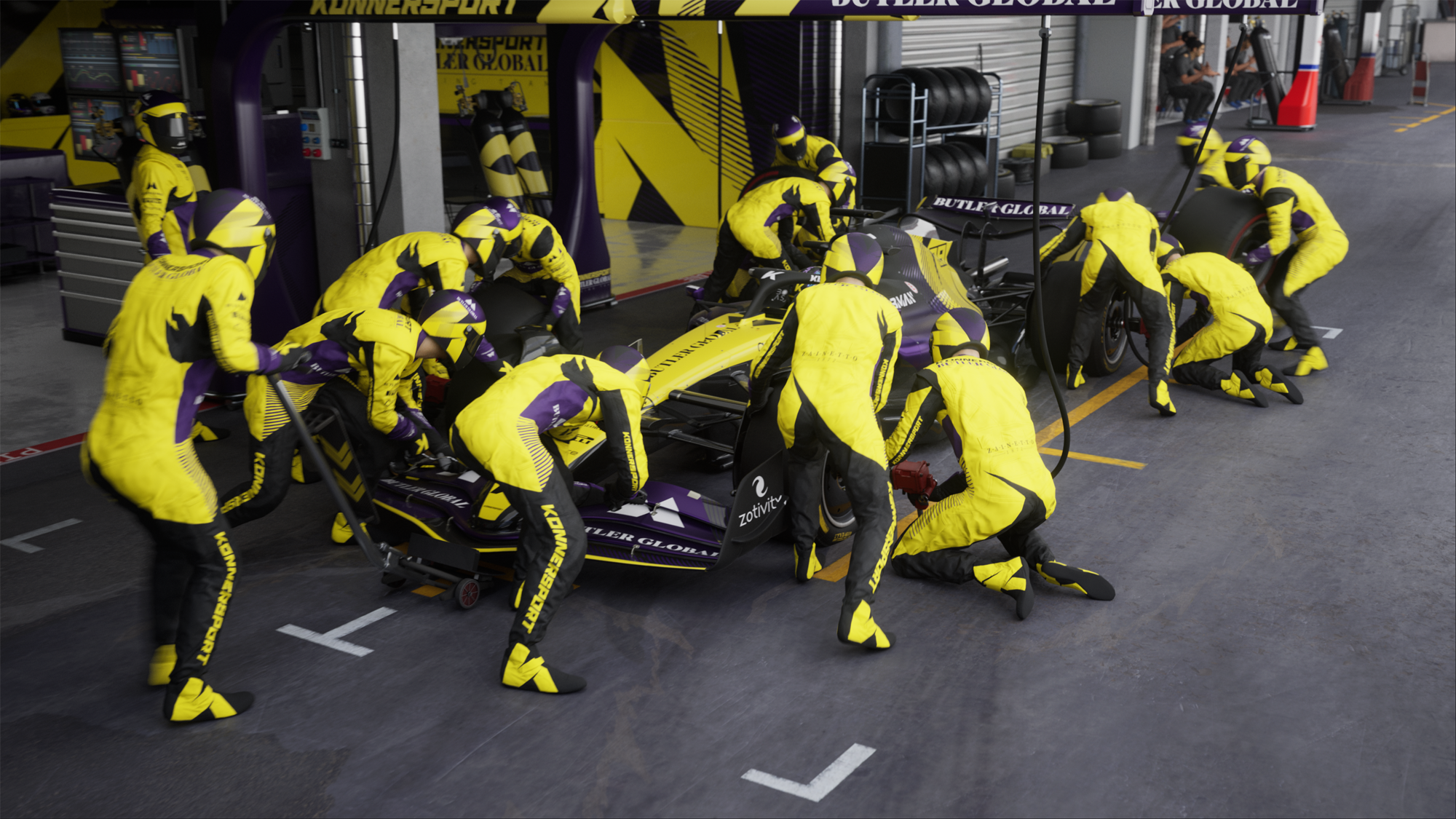 Eine Formel-1-Boxencrew, die in einer Garage an einem Auto arbeitet.