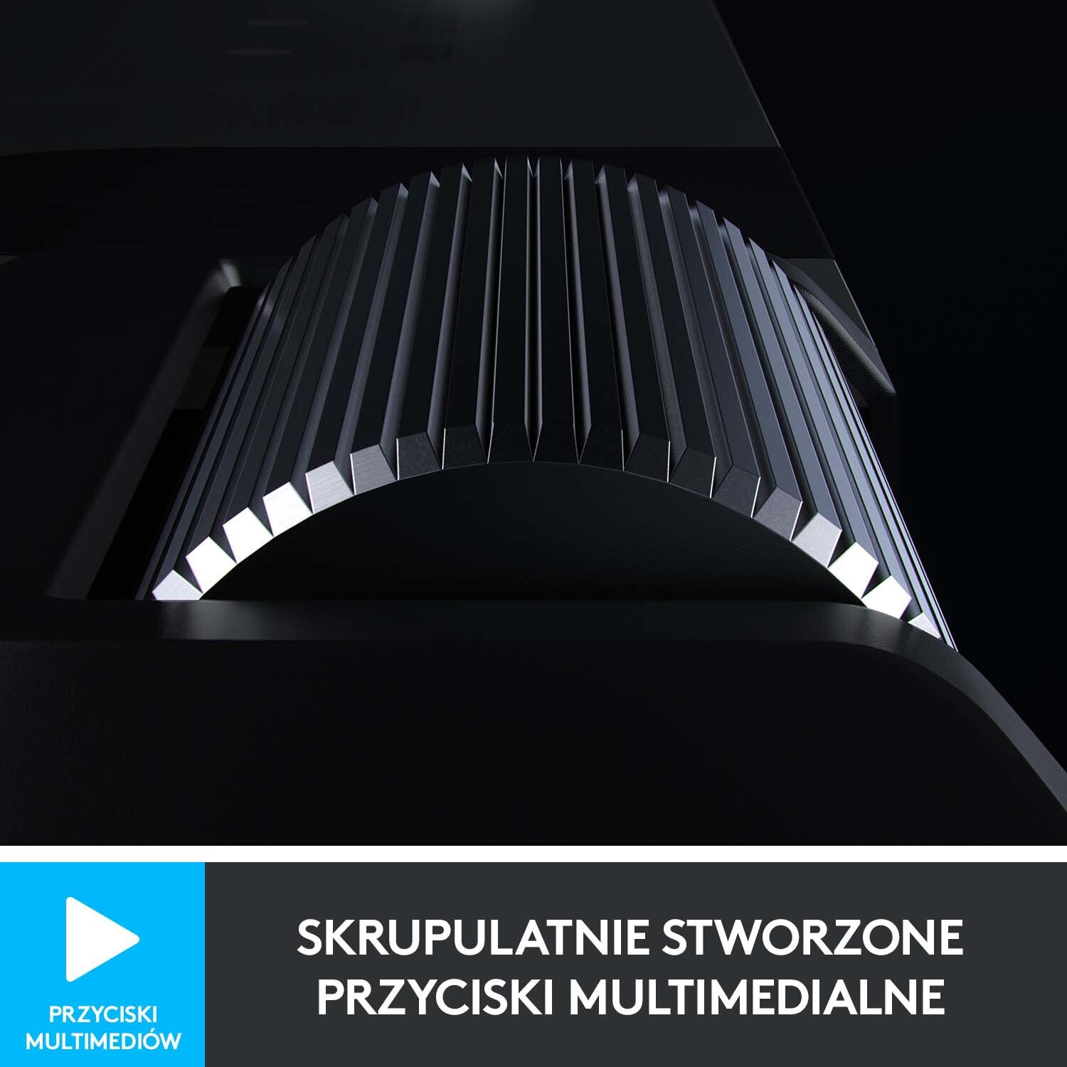 Zbliżenie pokrętła sterowania multimediami z napisem 'SKRUPULATNIE STWORZONE PRZYCISKI MULTIMEDIALNE'.