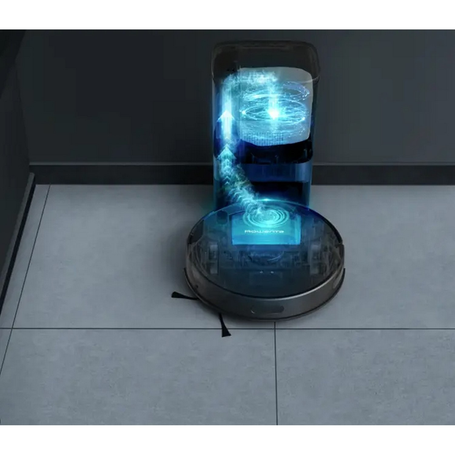Robot vacuum cleaner and charging station. Transparent top, showing internal mechanism. Tile floor, dark walls.