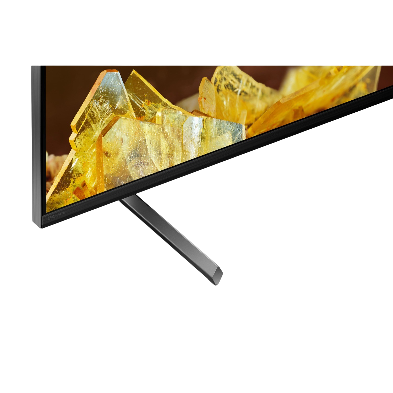 A close-up of a Sony TV. Showing the edge and stand with a landscape background.