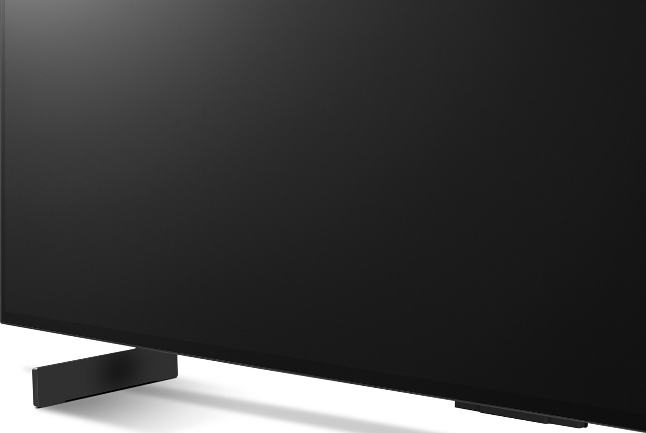 Téléviseur noir avec un pied fin. L'écran est noir. Design minimaliste.