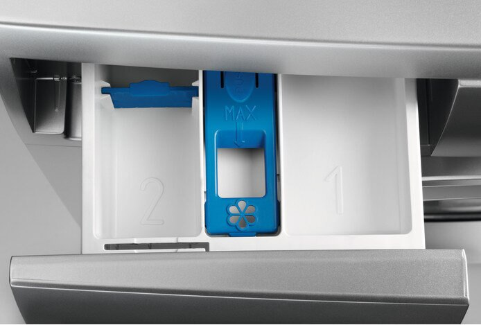 Zbliżenie na szufladę na detergent w pralce. Komory oznaczone '2' i '1'. Niebieska komora 'MAX'.