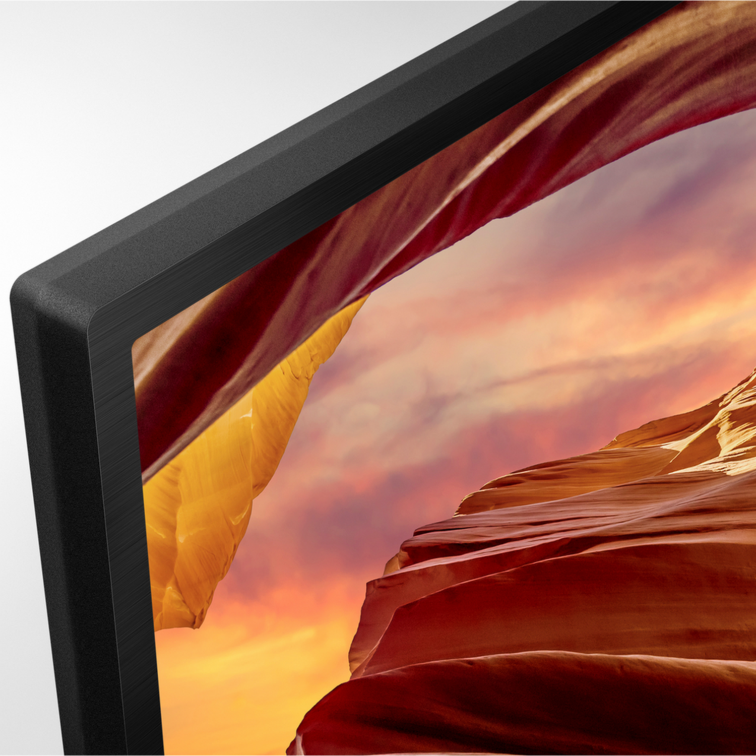 A black TV frame with a red and orange canyon landscape scene.