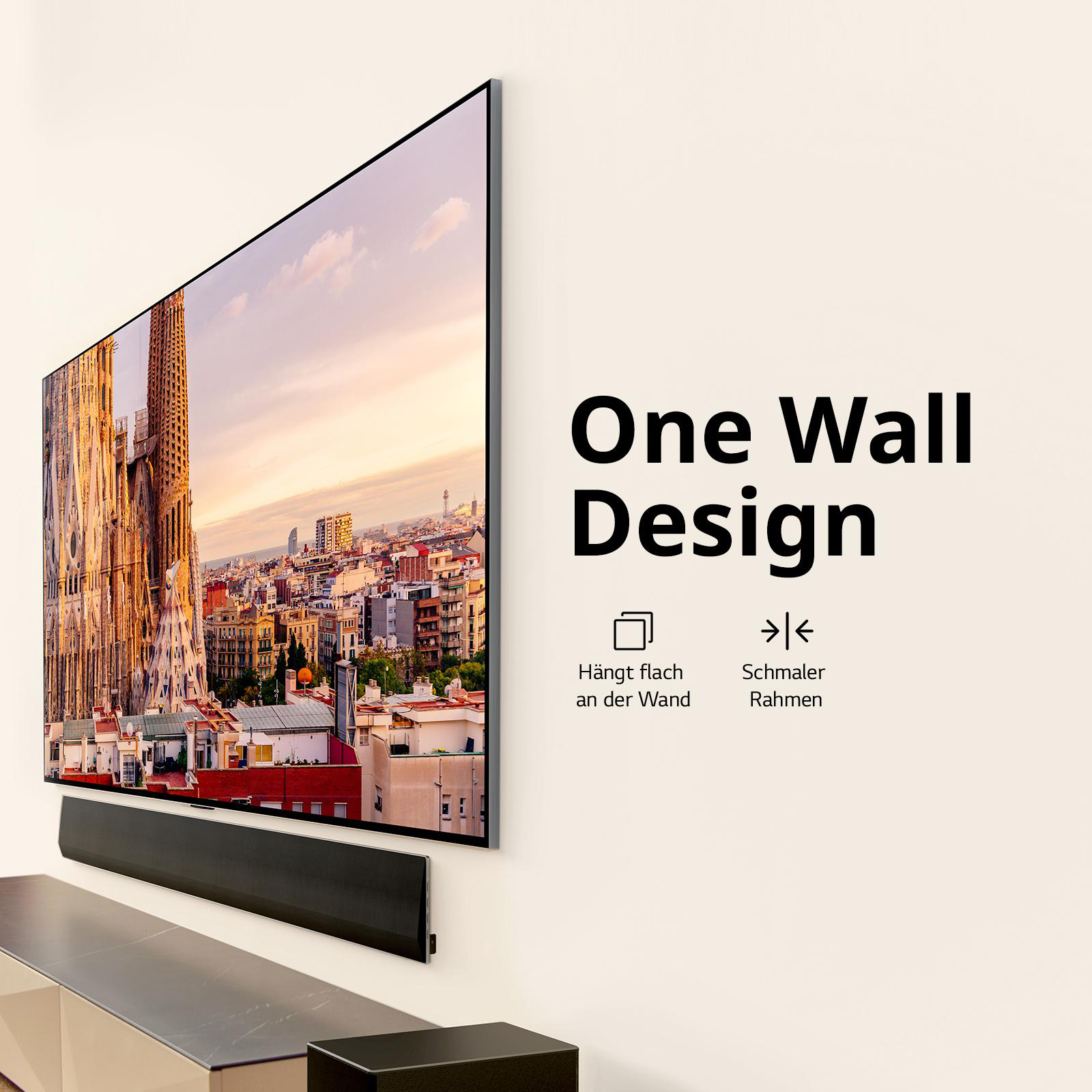 Ein an der Wand montierter Fernseher mit einer Soundbar darunter.