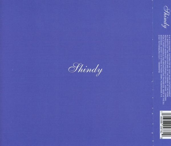 Blauer Umschlag mit dem Wort 'Shindy' in Kursivschrift. Die Rückseite eines Musikalbums.