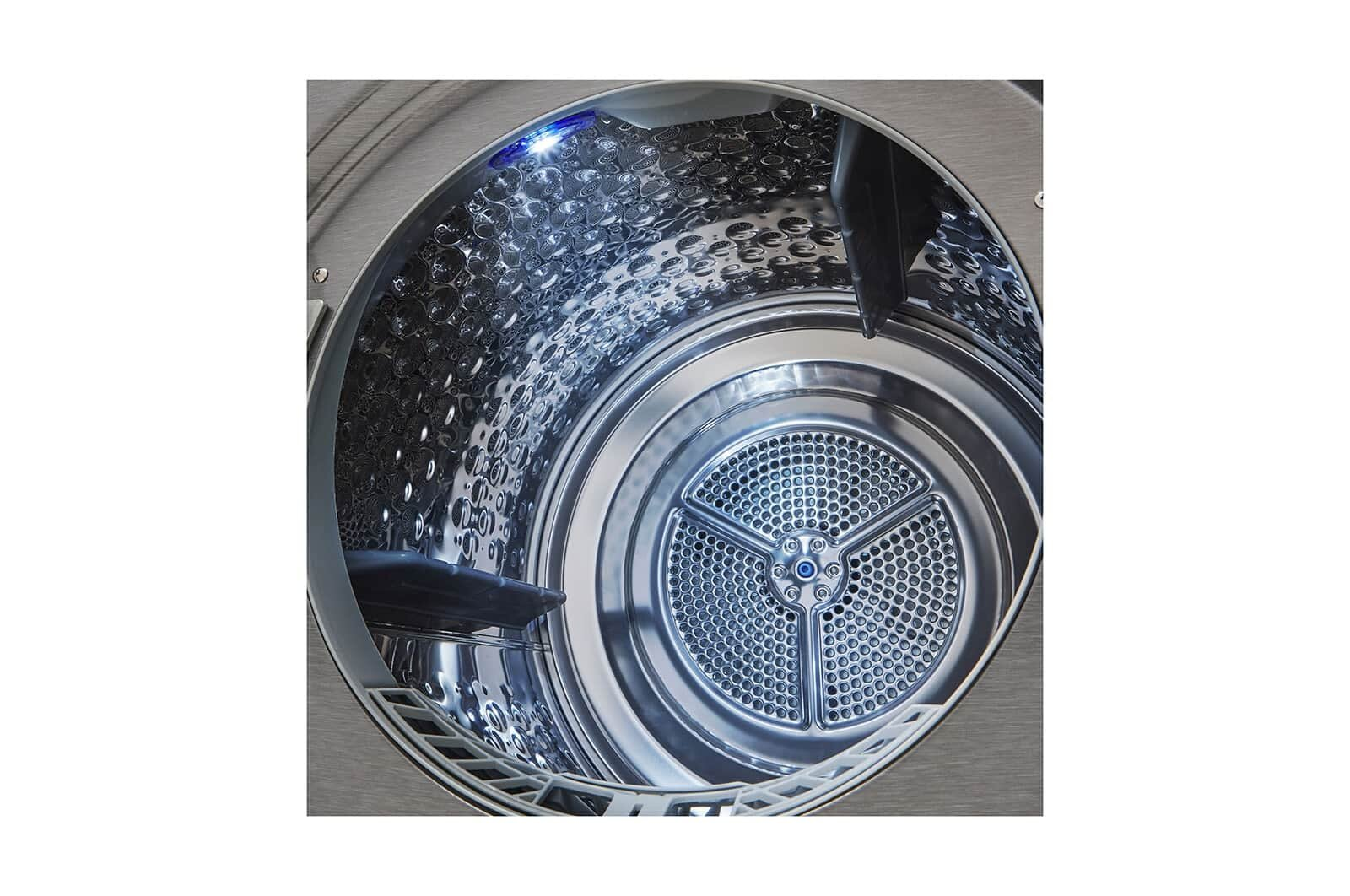 Wnętrze metalowego piekarnika. Wnętrze jest błyszczące. Z tyłu znajduje się wentylator.