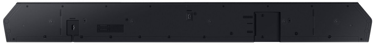 Czarny soundbar. Z tyłu znajdują się porty i śruby. Jest prostokątny i ma wiele otworów.