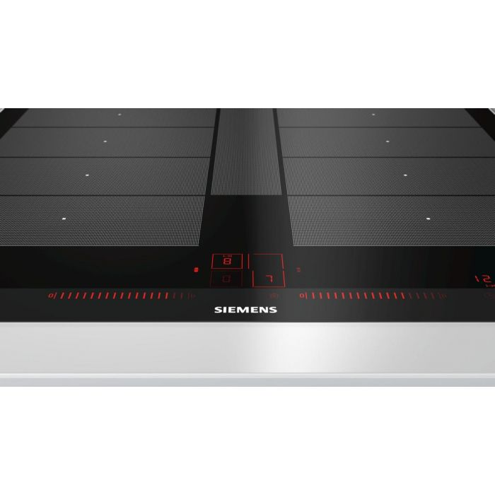 Primer plano de una placa de inducción negra con números rojos iluminados y un logotipo de 'Siemens'.