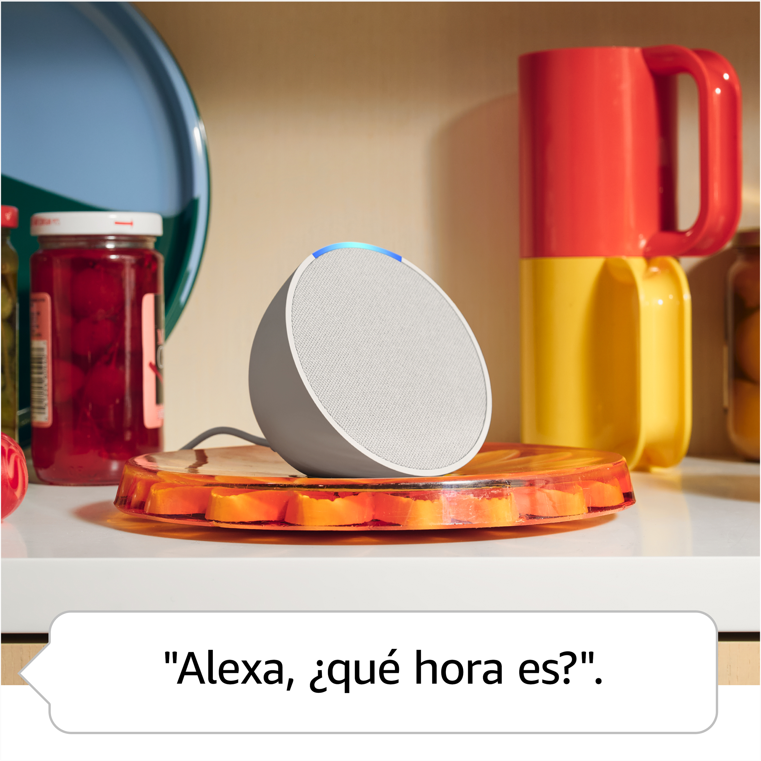 Altavoz inteligente blanco y gris sobre una mesa. Hay una burbuja de diálogo con texto en español.