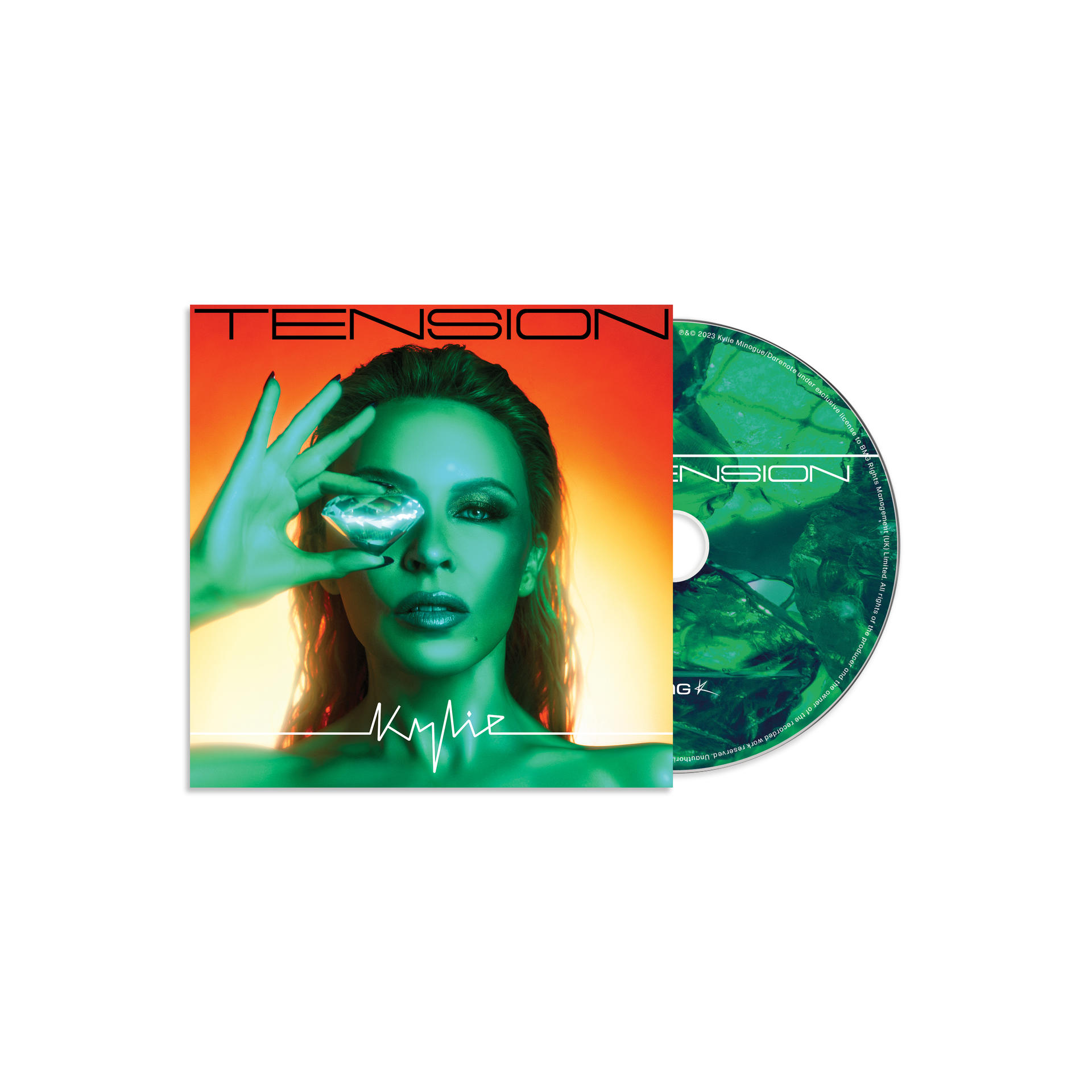 Een Kylie albumhoes met een groene tint en een cd. Kylie houdt een diamant bij haar oog.
