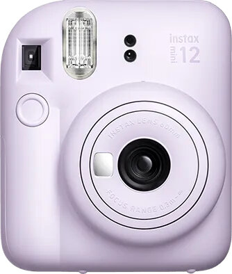 Jasnofioletowy aparat Instax Mini 12. Widoczny obiektyw i lampa błyskowa. Białe tło.