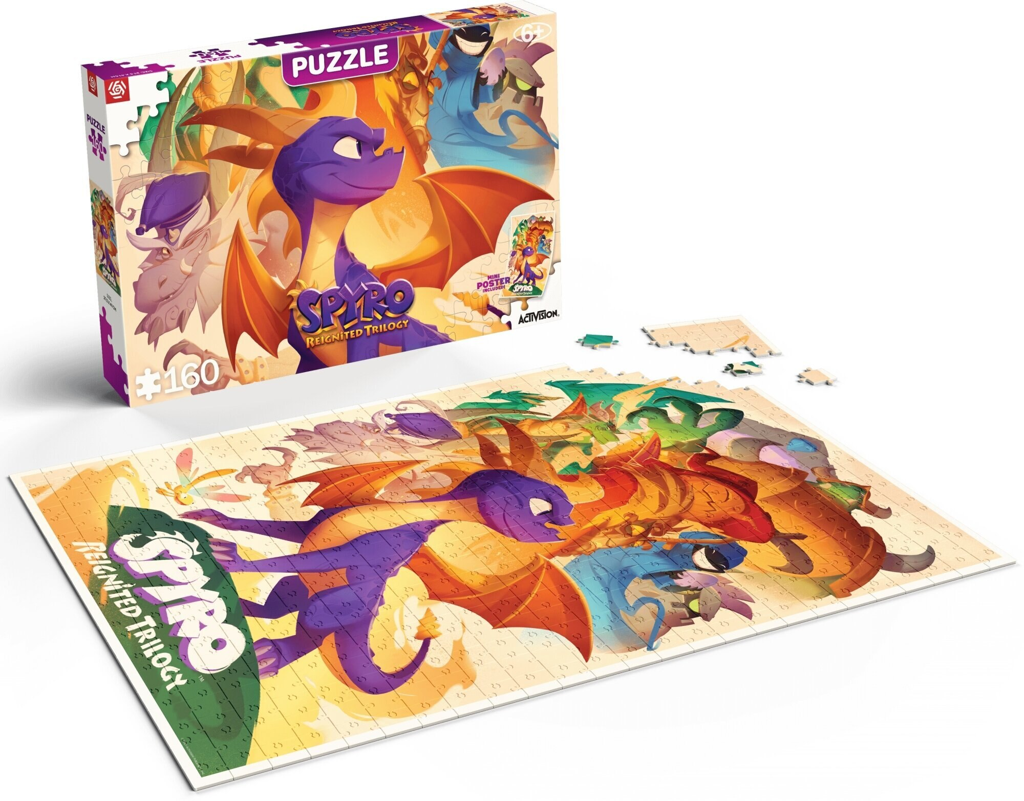 Pudełko z puzzlami i złożone puzzle Spyro the Dragon. Pudełko przedstawia grafikę smoka. Puzzle mają obrazy smoków.