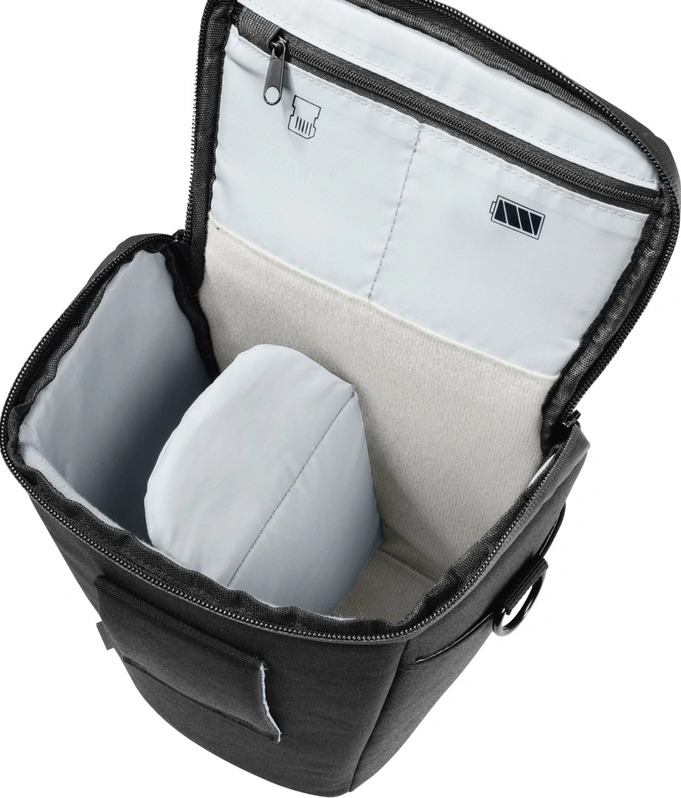Open black camera bag with compartments, a lens cap, and a battery icon inside.