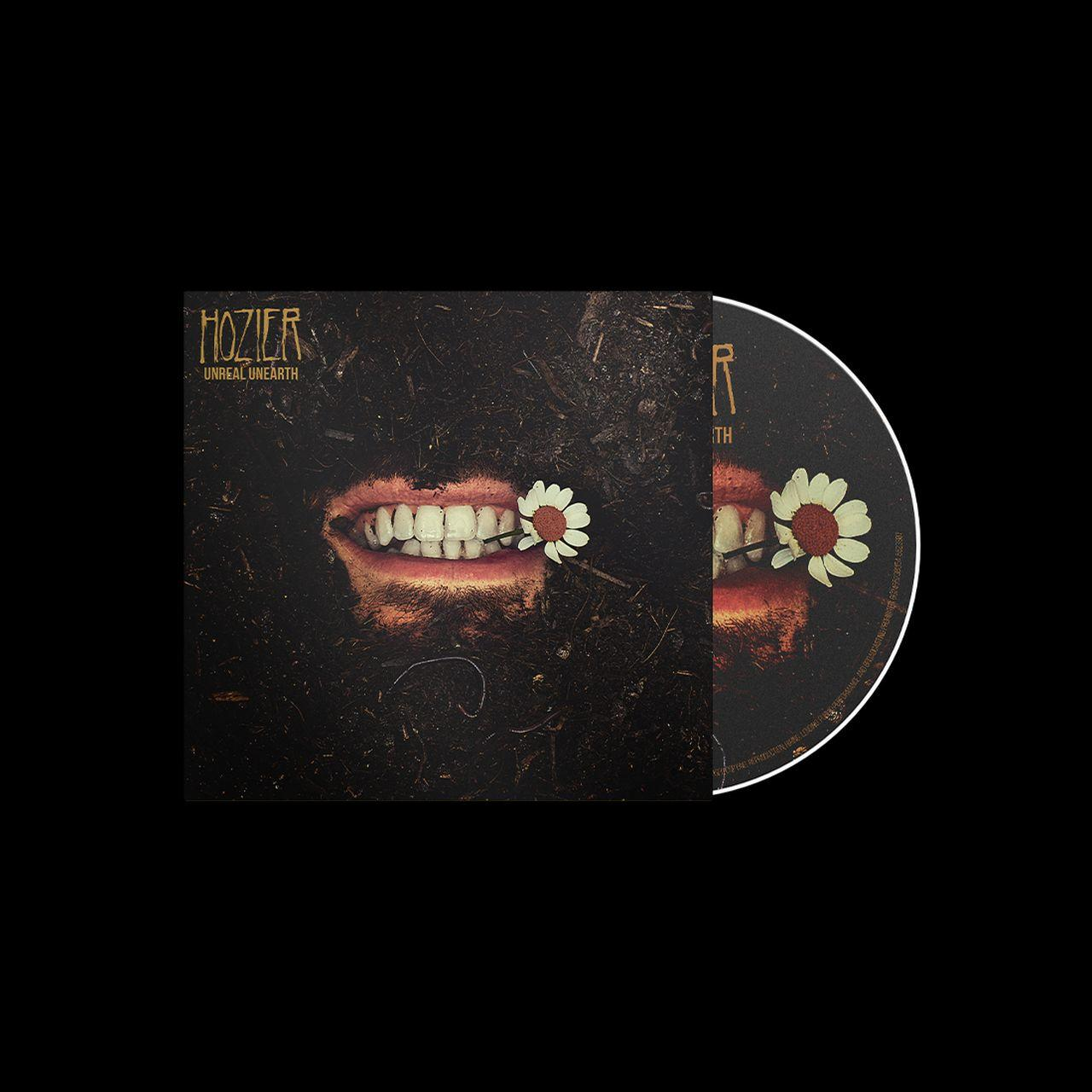 Album borítója egy személy szájával, virágokkal és az 'Unreal Unearth' címmel. CD mellette.