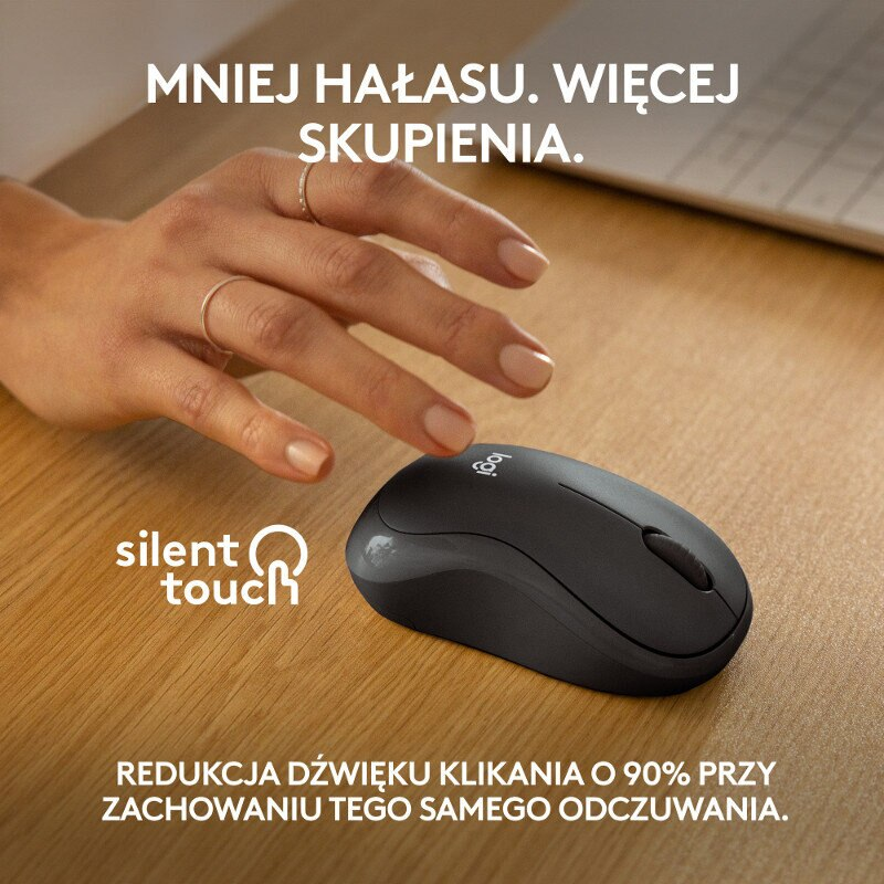 Czarna mysz Logitech na drewnianym stole. Nad nią unosi się dłoń.