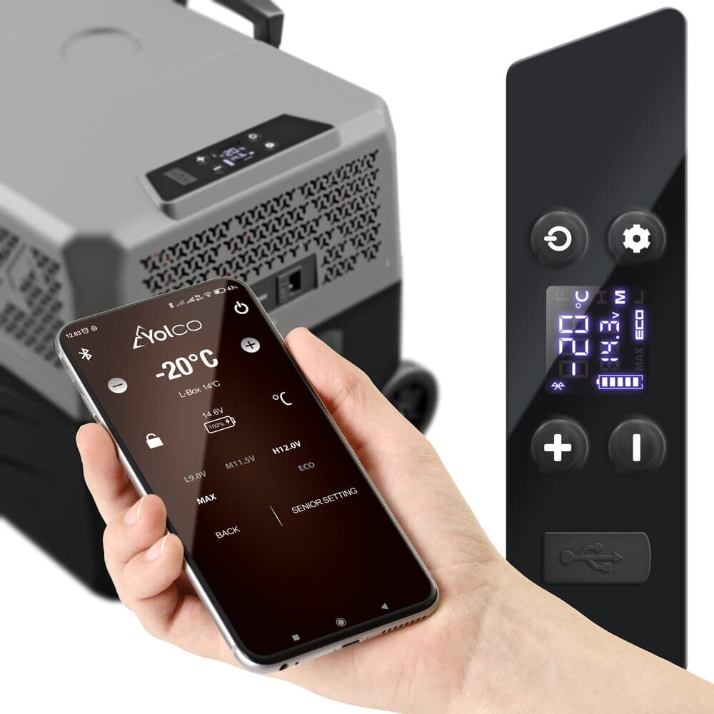 Telefon pokazuje -20°C na wyświetlaczu lodówki, obok pilota.