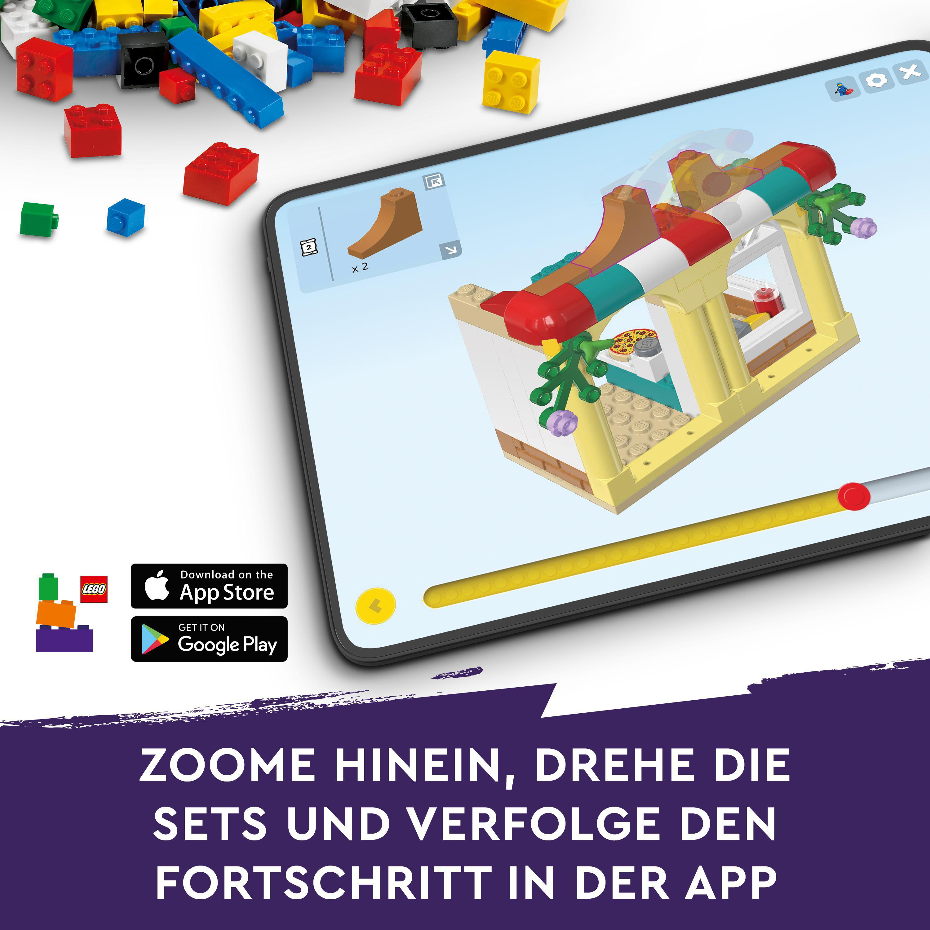 Ein Tablet zeigt ein LEGO-Bauset. Text unten: 'Vergrößern, drehen...'