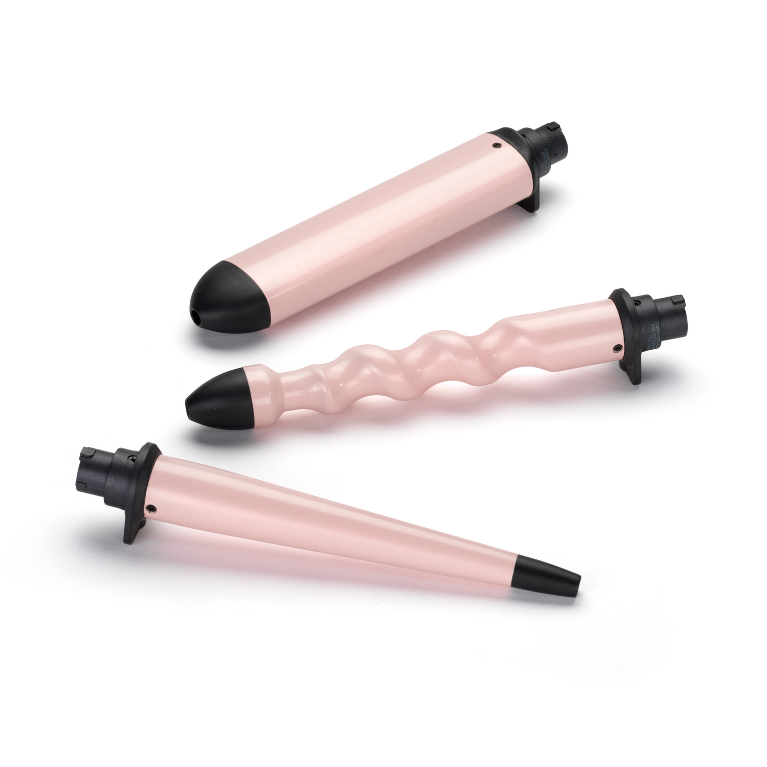 Drie roze krulopzetstukken. Verschillende vormen: kegel, cilinder en golf.
