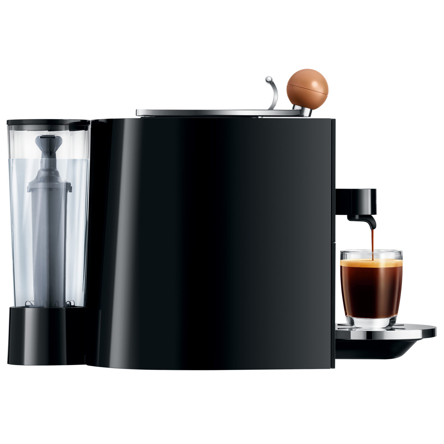 Black coffee machine. Water container, coffee is pouring into a glass. Brown ball on top.