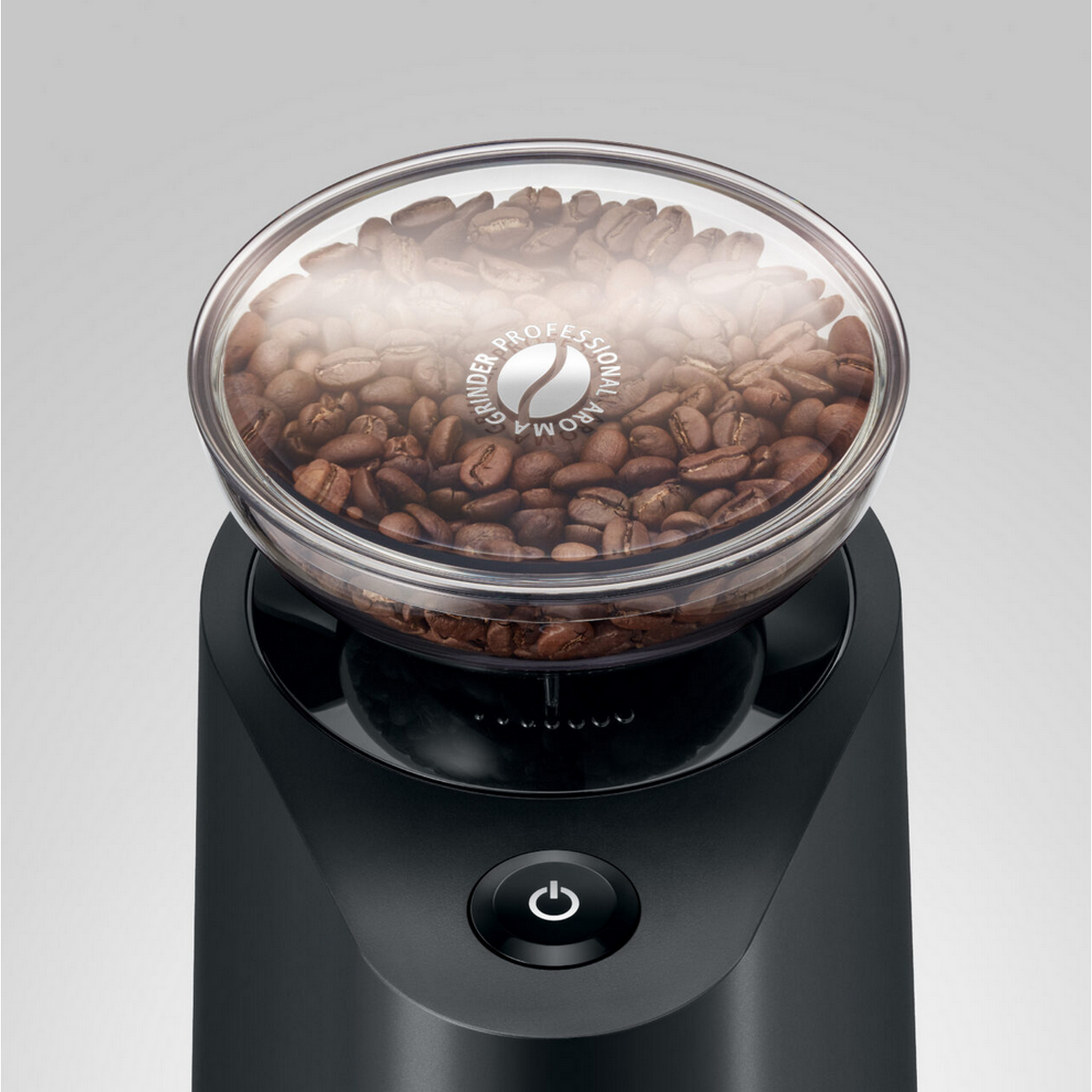 Coffee grinder with clear top filled with coffee beans, black base, power button.