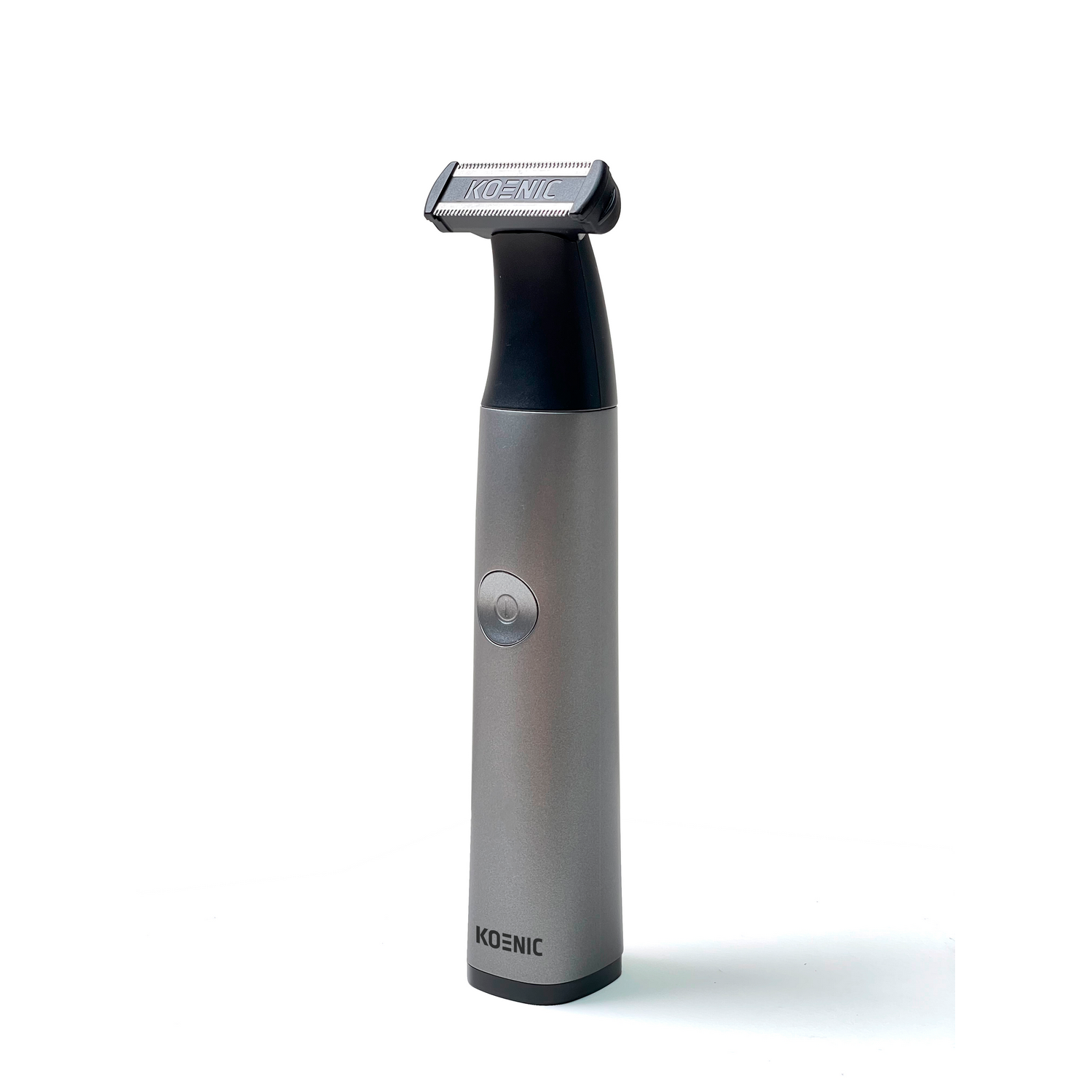 Gray Koenic body hair trimmer. It is standing upright and has a black trimming head on top.