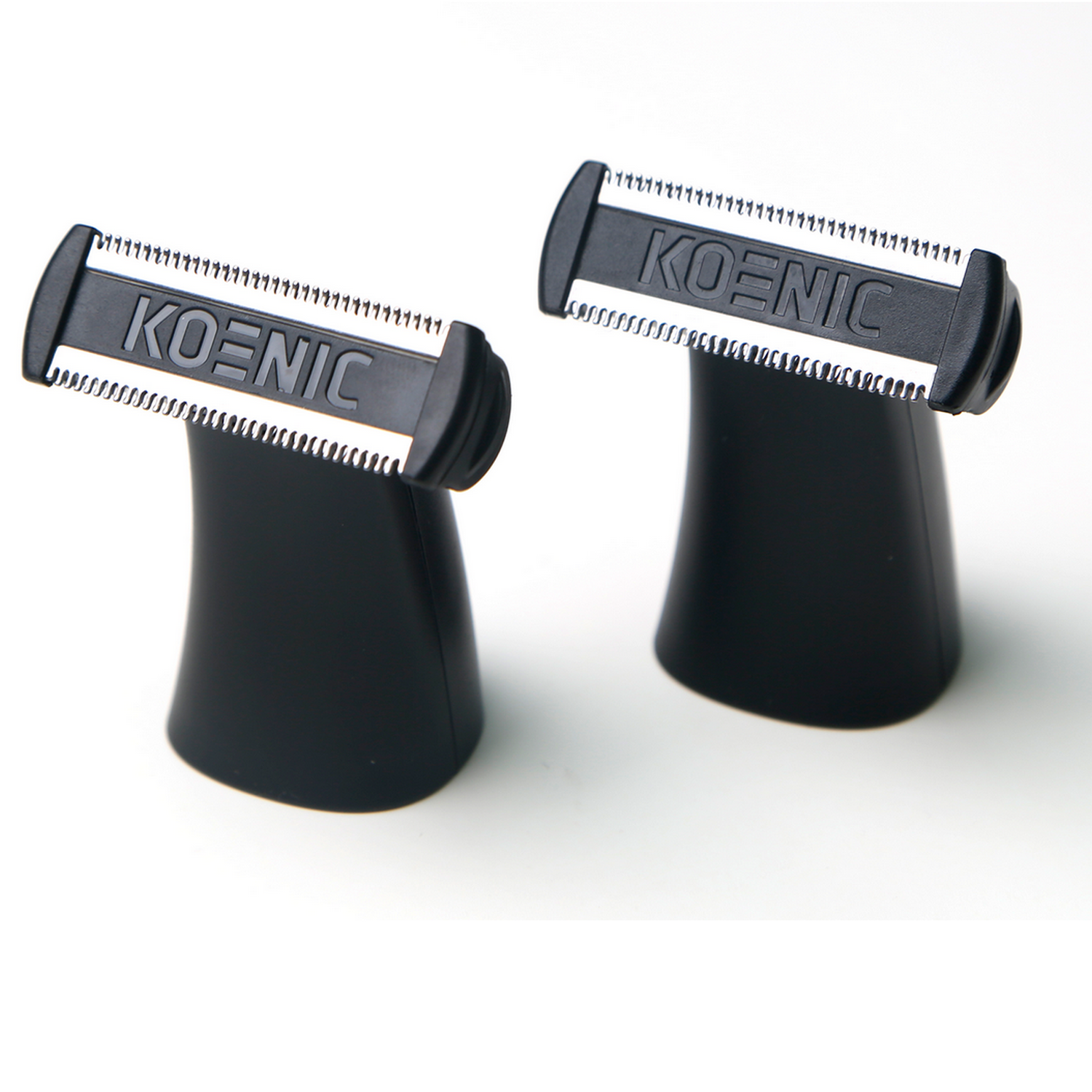 Two black Koenic razor heads on black stands, blades face up.