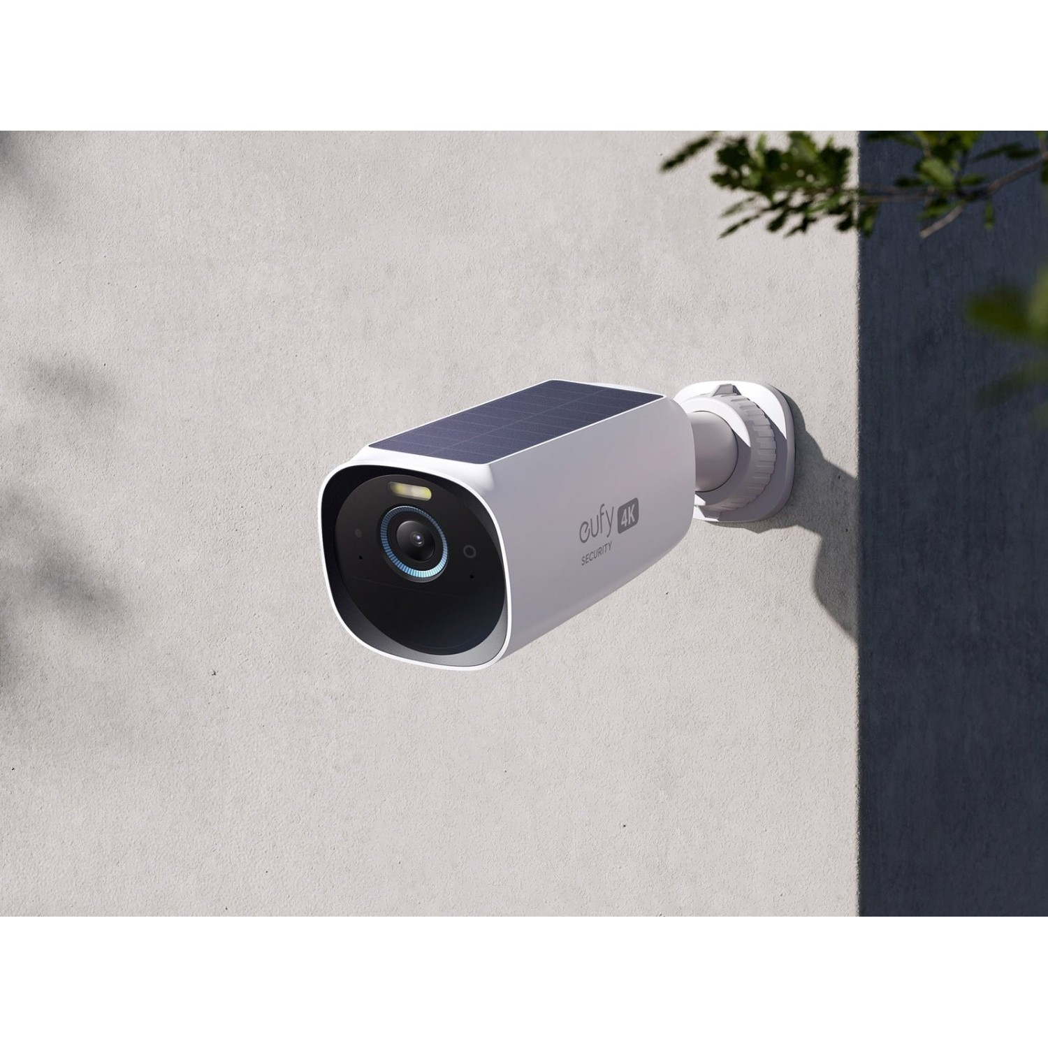 A white outdoor security camera mounted on a wall.