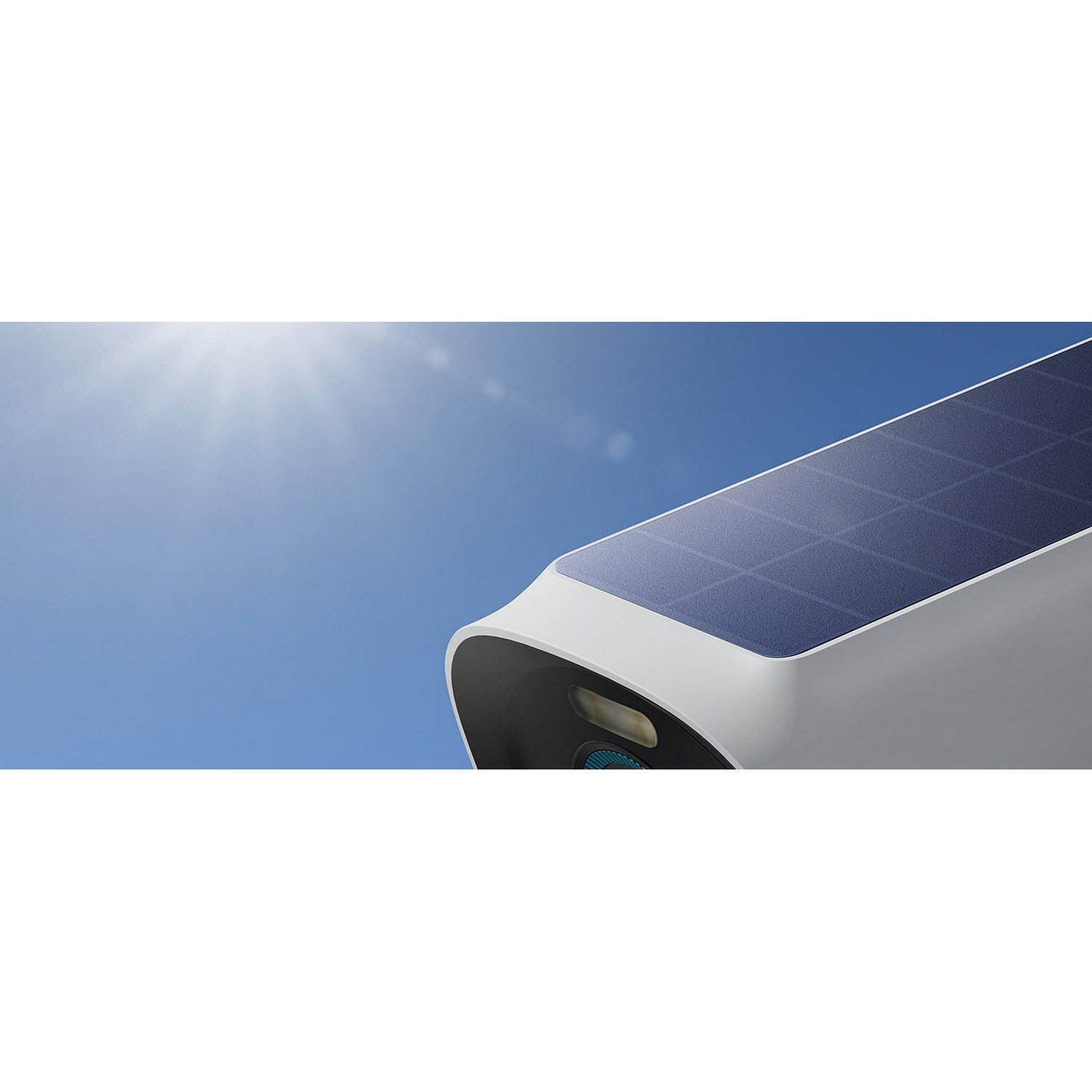 A security camera with a solar panel on top, against a bright blue sky.