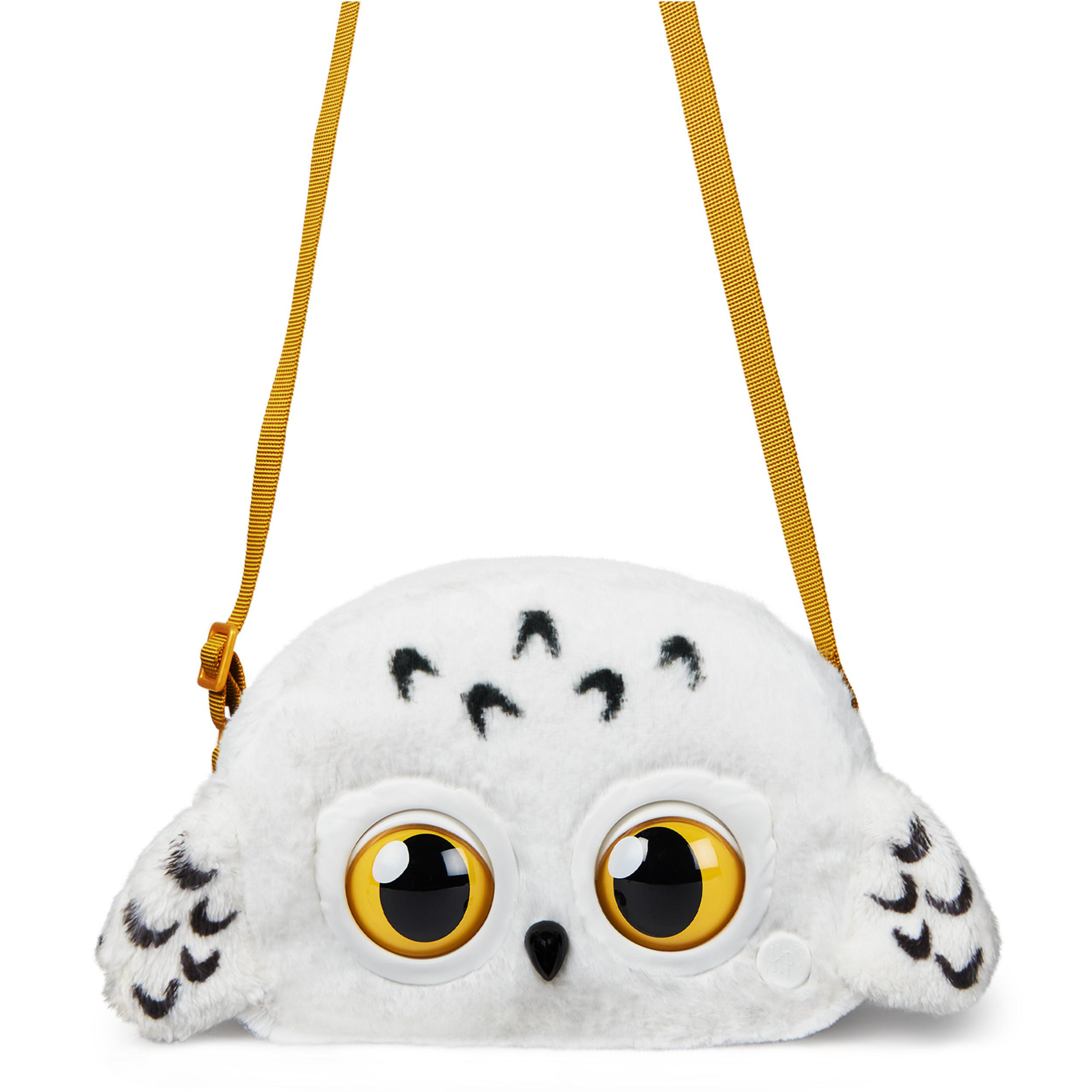 Weiße, eulenartige Tasche mit gelbem Riemen und Augen.