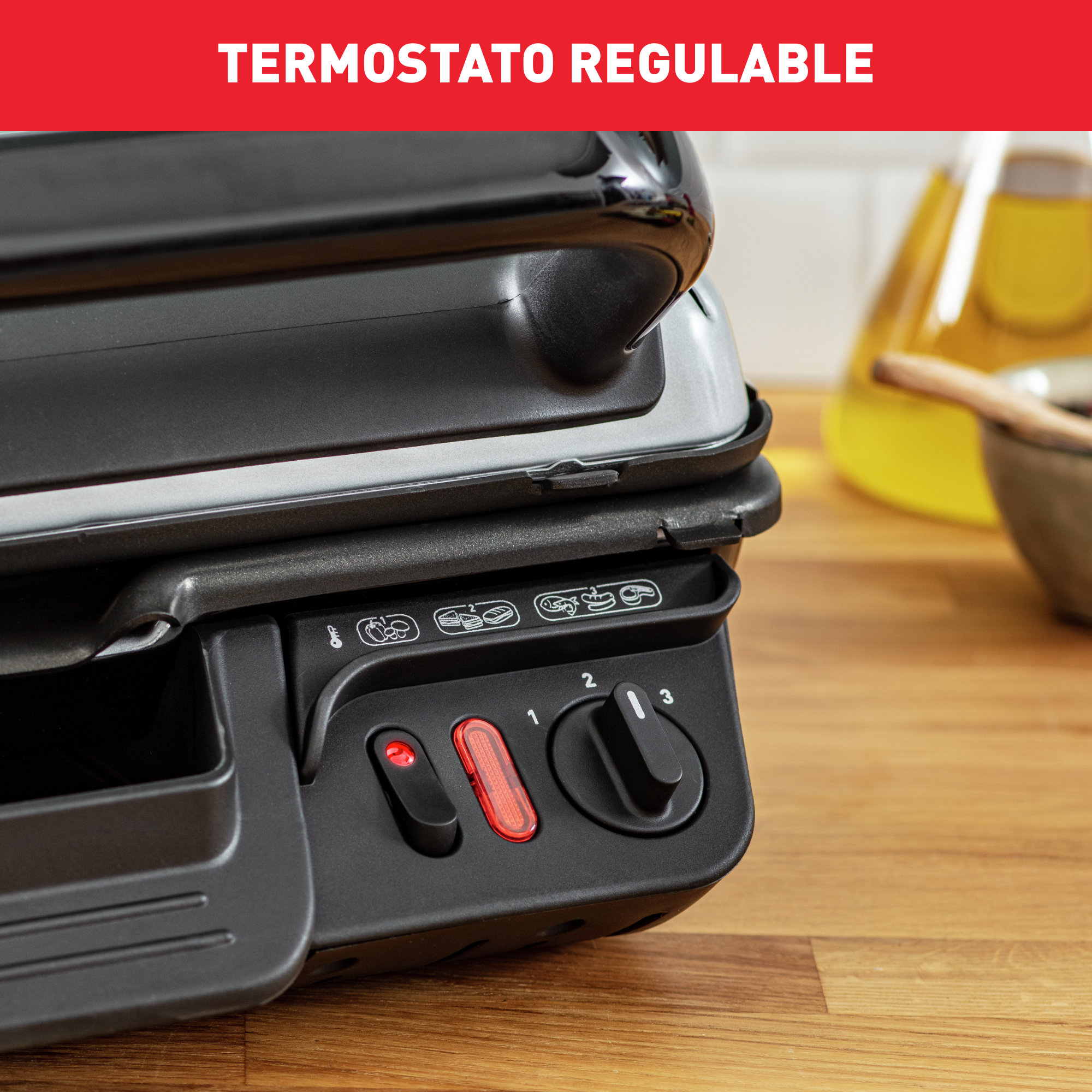 Primer plano de una parrilla negra y gris con termostato ajustable.