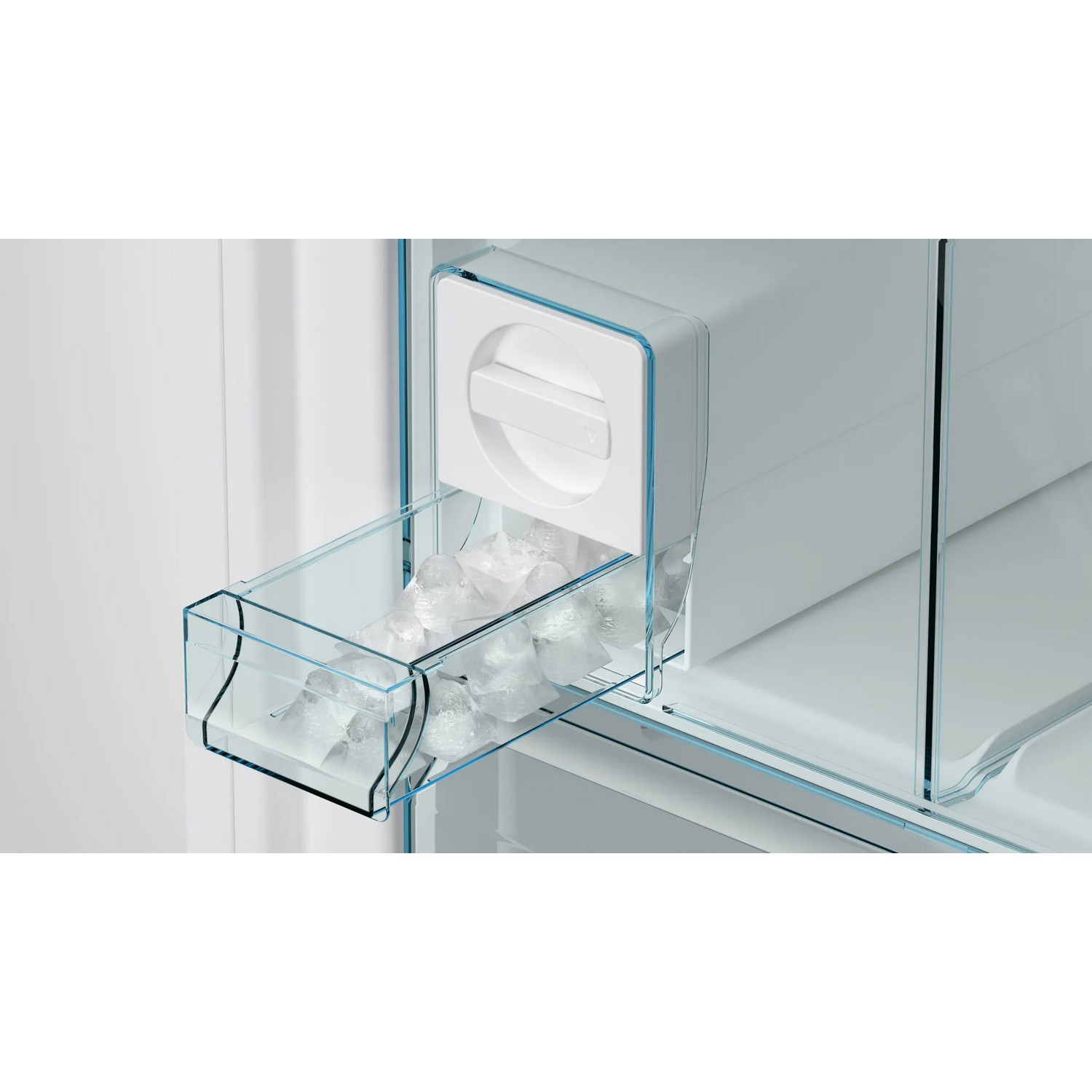 A refrigerator ice maker with a clear container holding ice cubes.