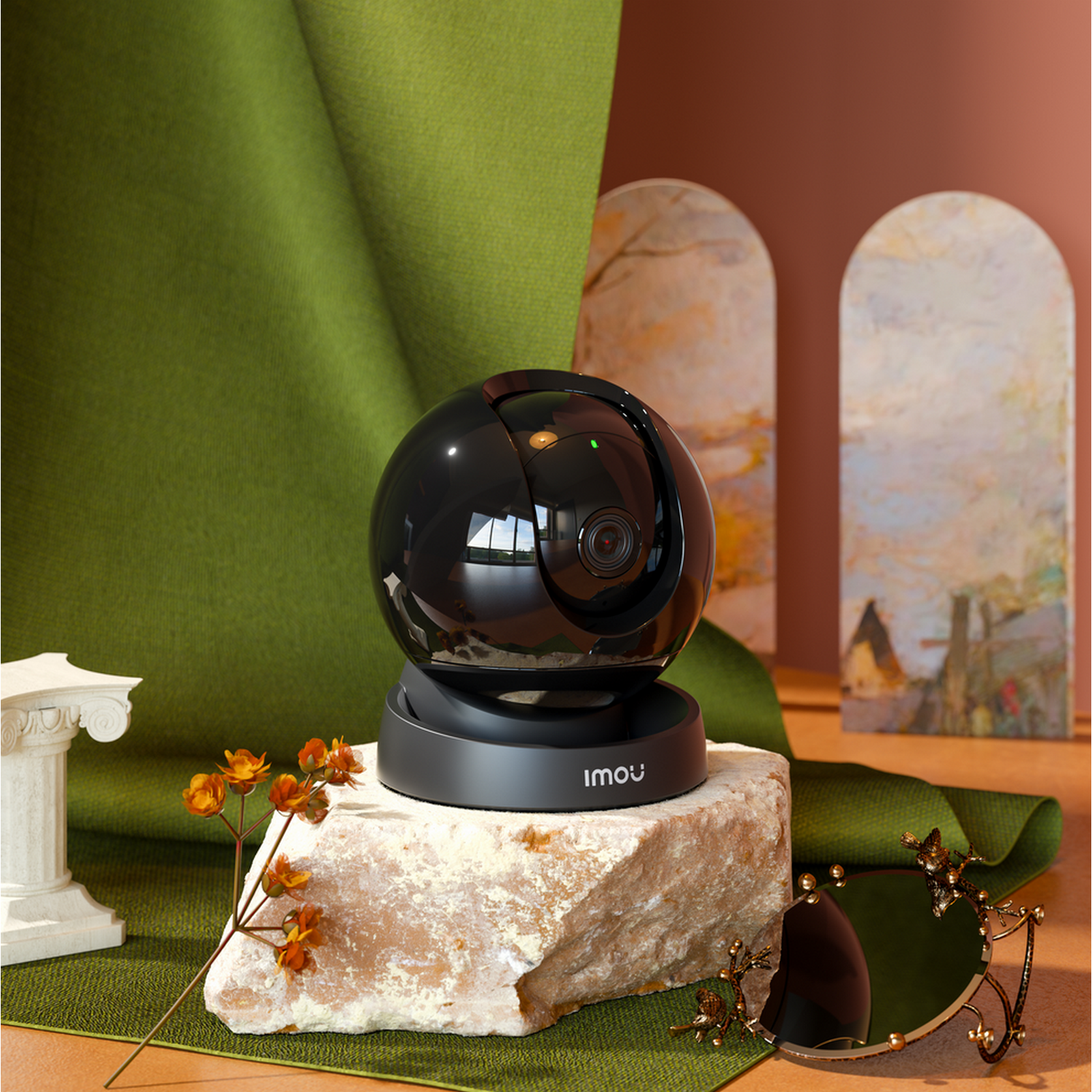 Black, round camera on a stone. Green, brown, and white background with decorations.