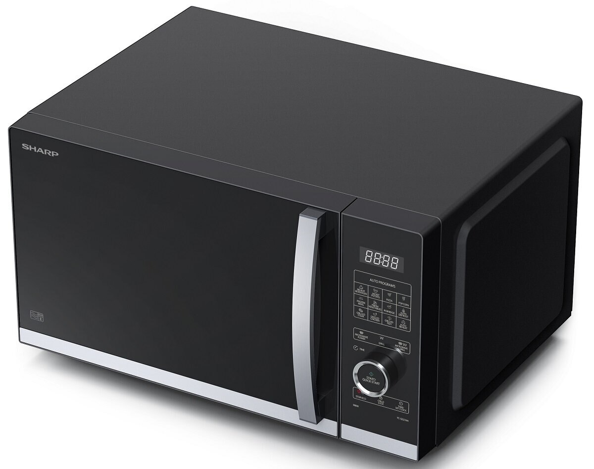 Czarna kuchenka mikrofalowa Sharp. Posiada cyfrowy wyświetlacz, panel sterowania i srebrny uchwyt. Znajduje się na białej powierzchni.